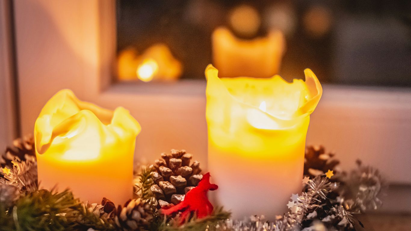 yellow pillar candle on brown wooden table