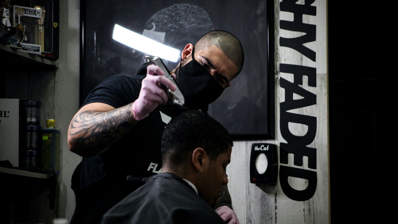 man in black shirt holding black smartphone