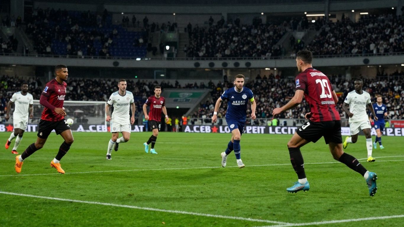 Football match in progress with players on the field.