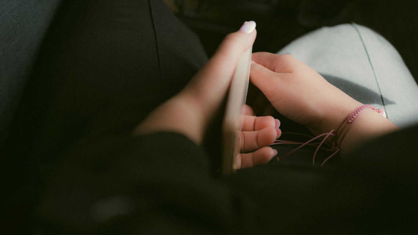 a close up of a person holding a cell phone