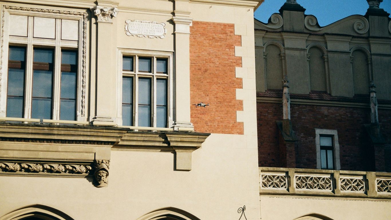 a building with arches and a clock on the front of it