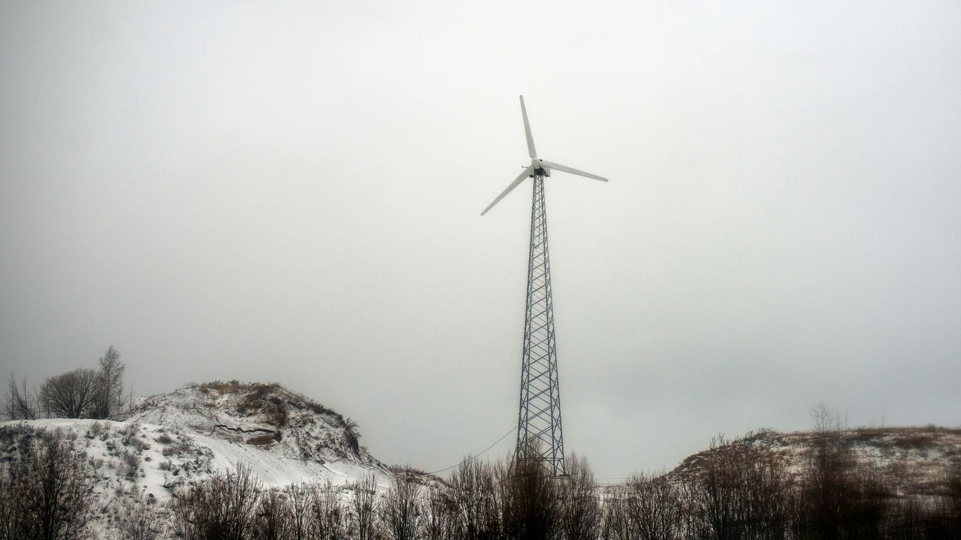 A wind turbine in the middle of a snowy field