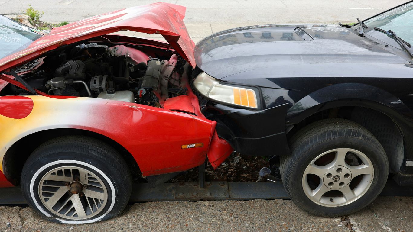 Cars are involved in a frontal collision.