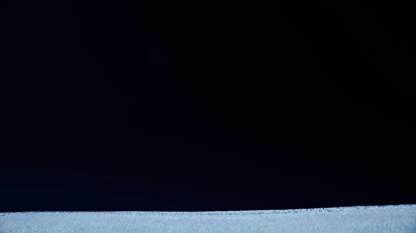 a black and white photo of a person holding a cell phone