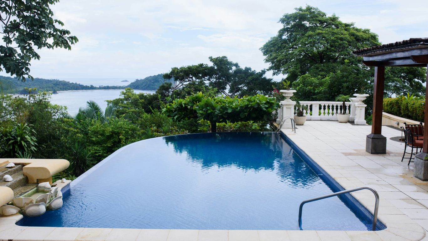 swimming pool near green trees during daytime