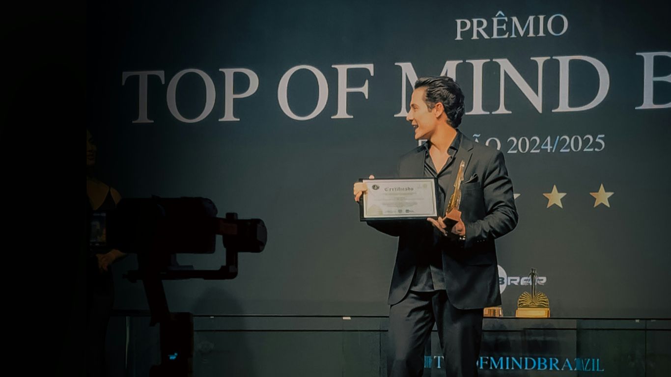 Man in suit accepts award on stage