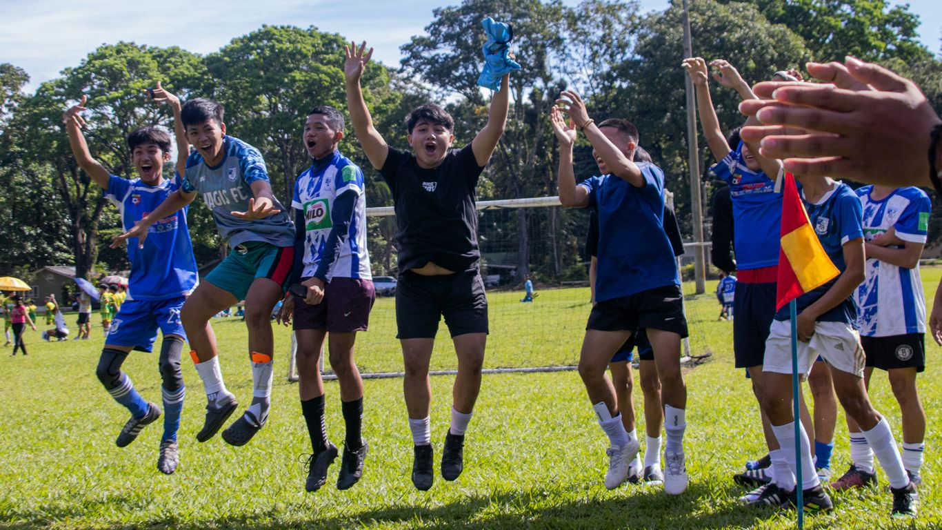 a group of young people playing a game of soccer