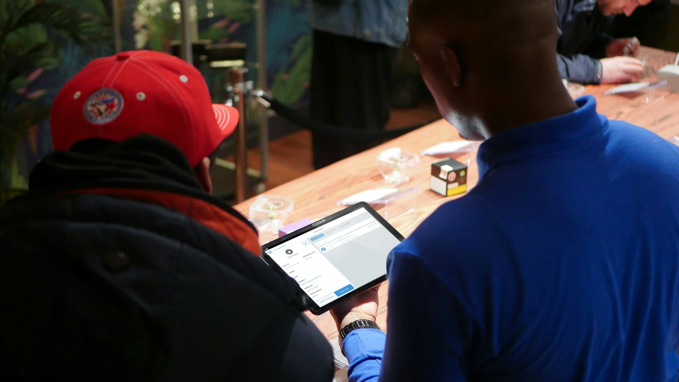 a group of people sitting around a wooden table