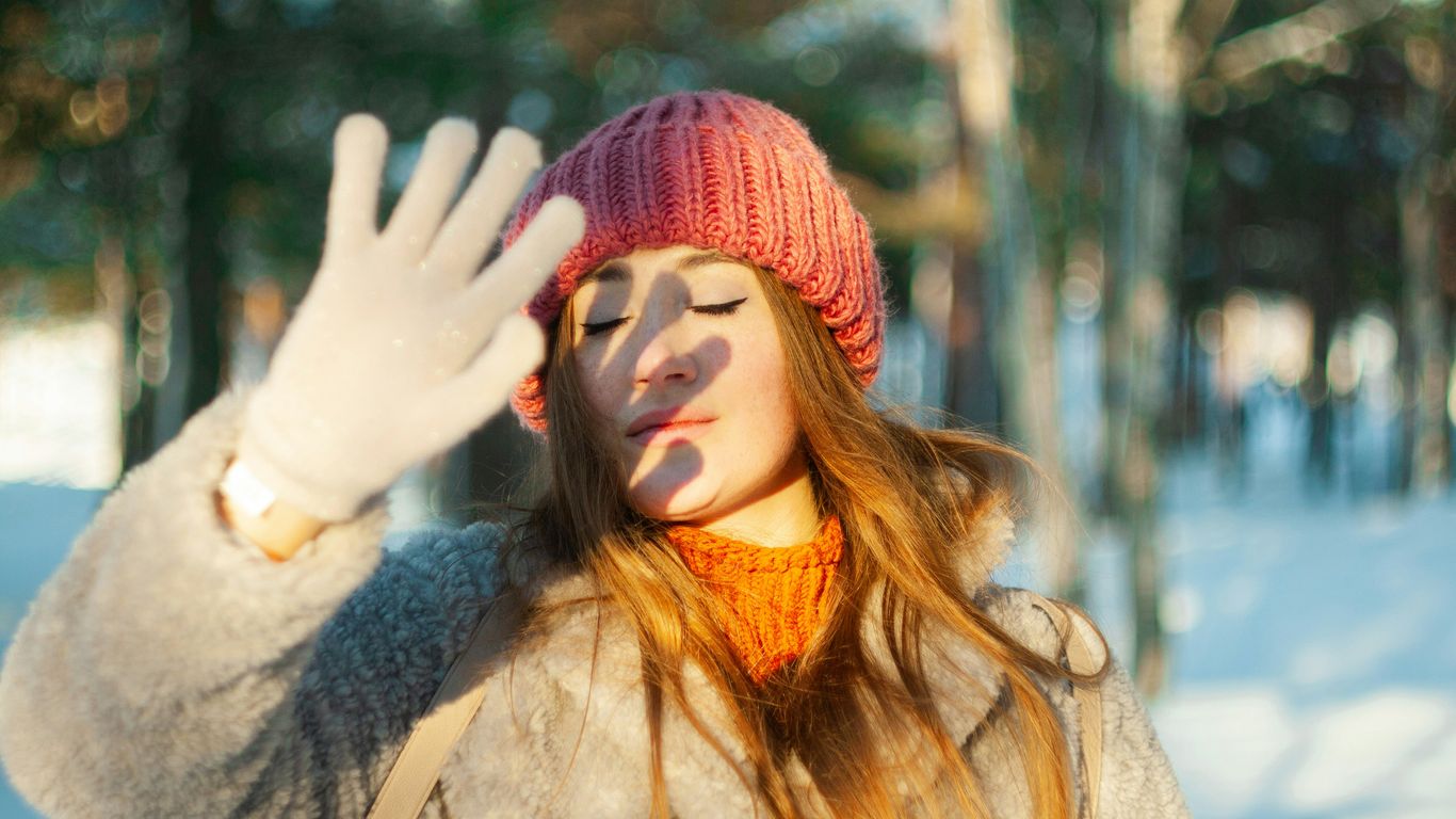 a woman wearing a pink hat and gloves