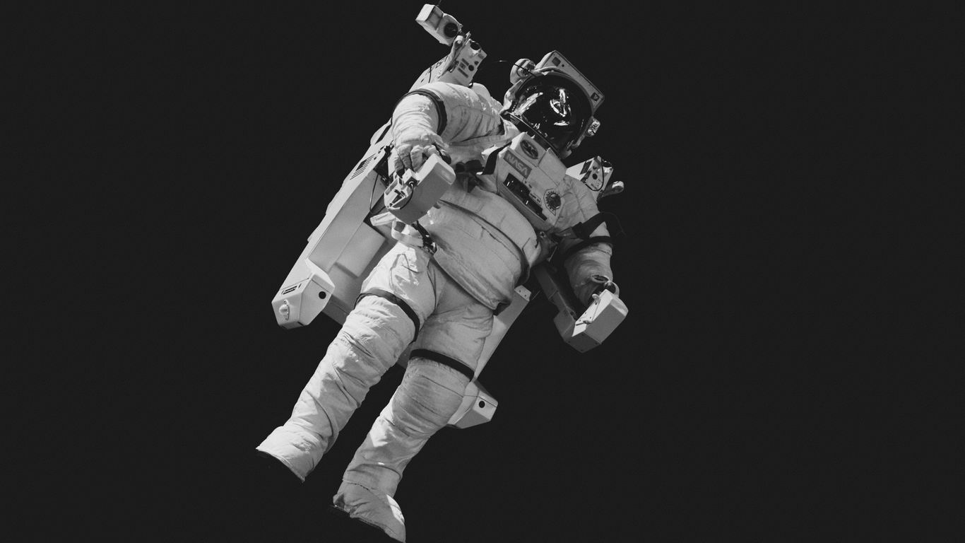 astronaut in white suit in grayscale photography