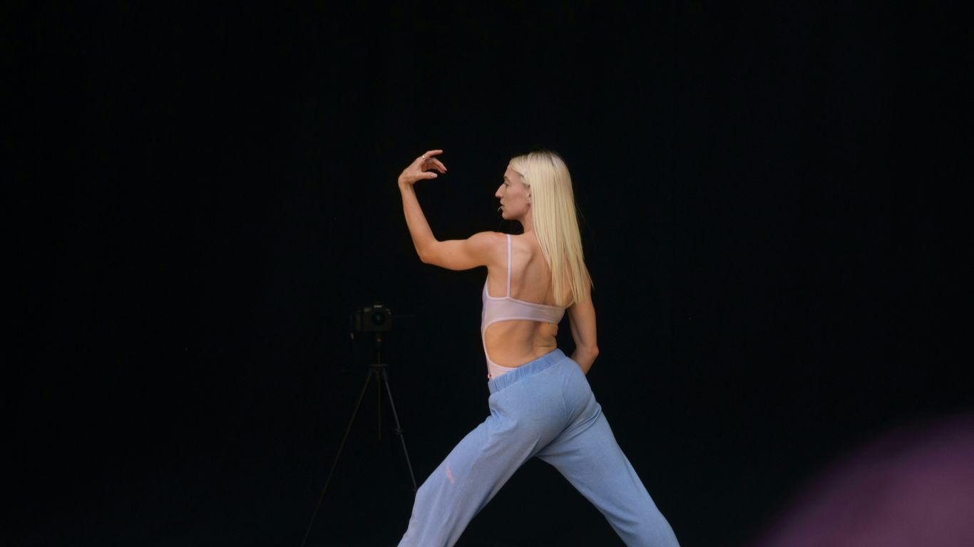 woman in white tank top and blue denim jeans