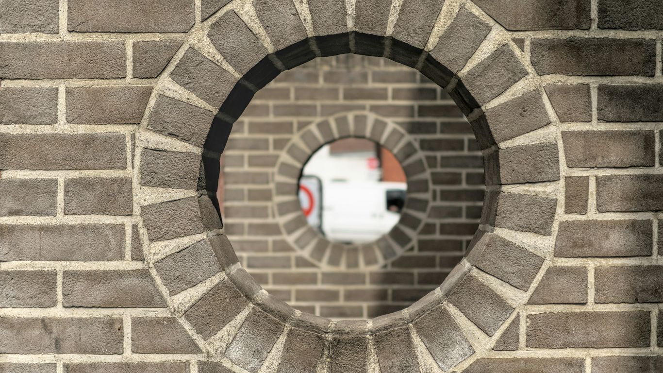 brown brick tunnel with hole