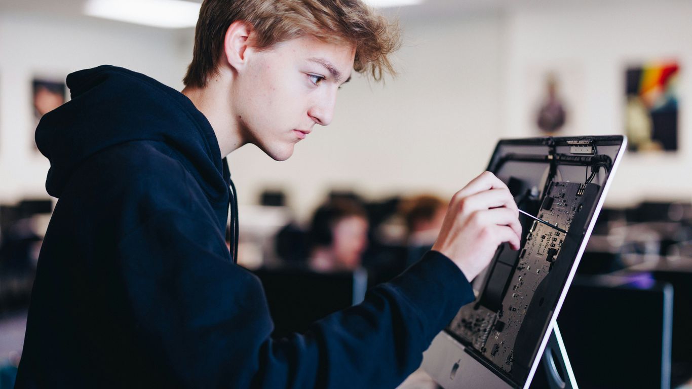 a young man working on a laptop computer