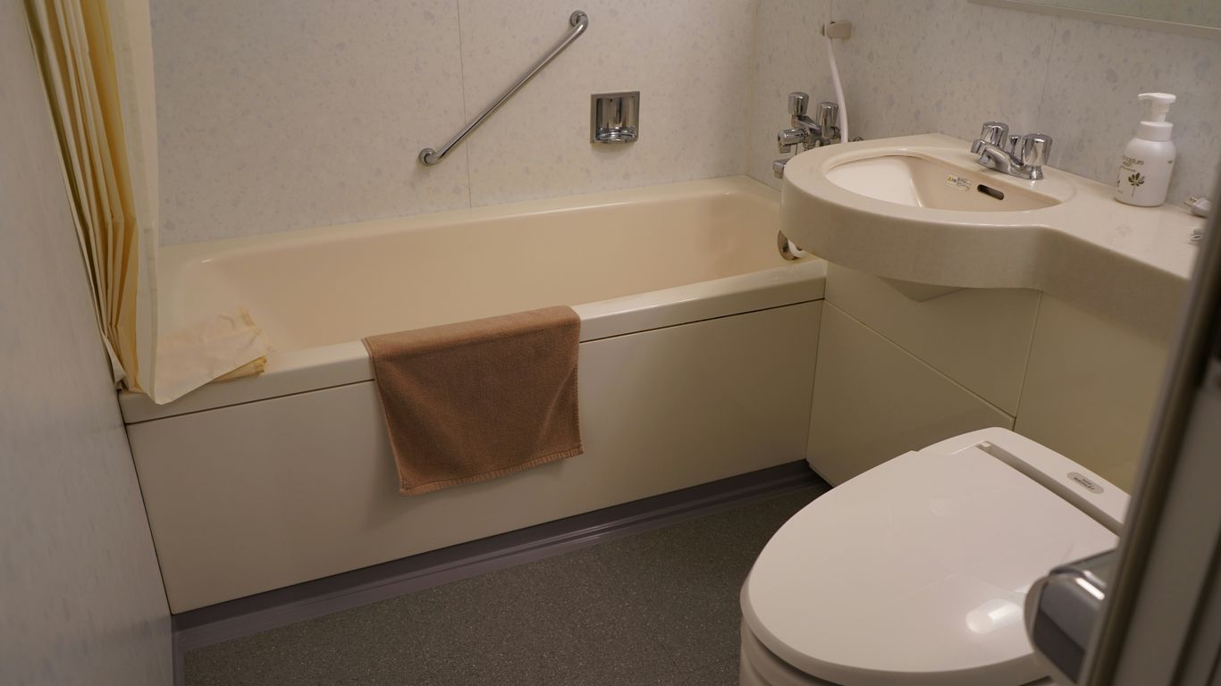a bathroom with a tub sink and toilet