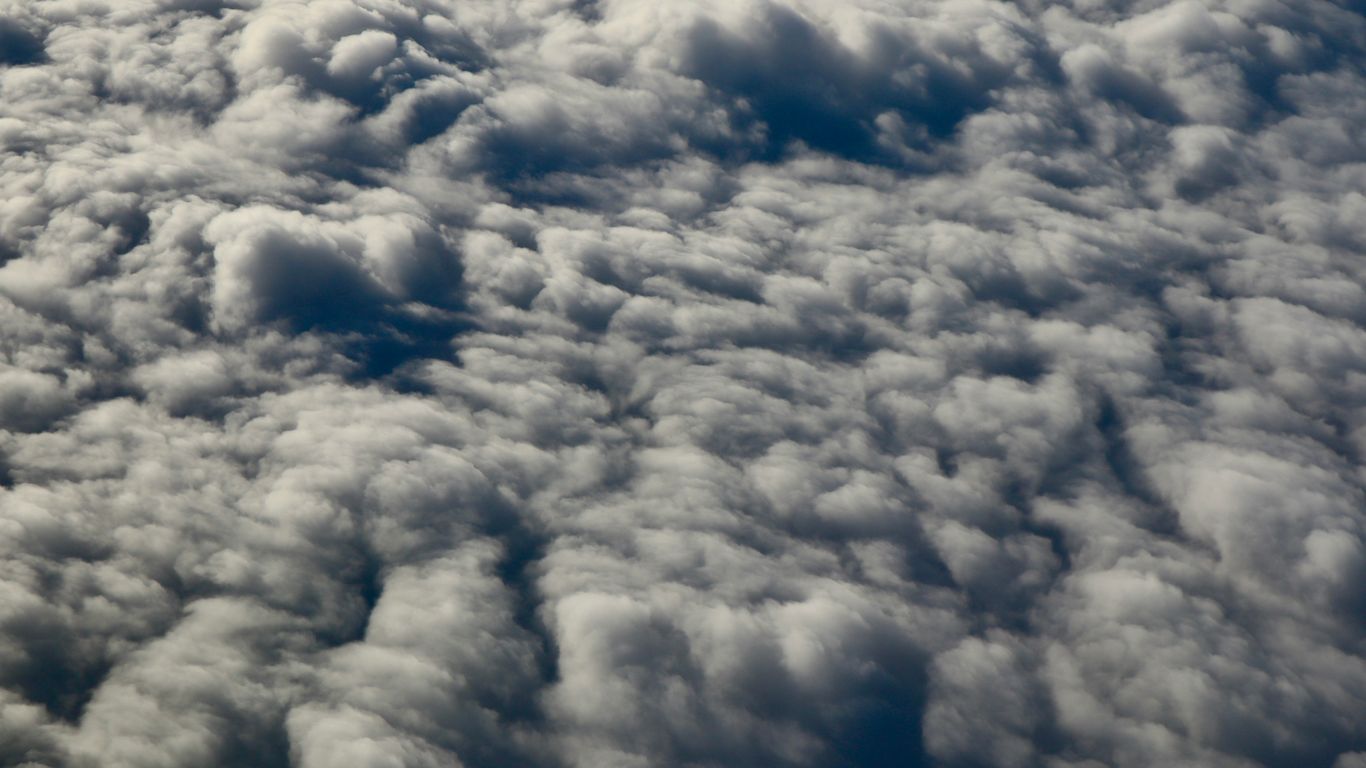 Fluffy white clouds seen from above.