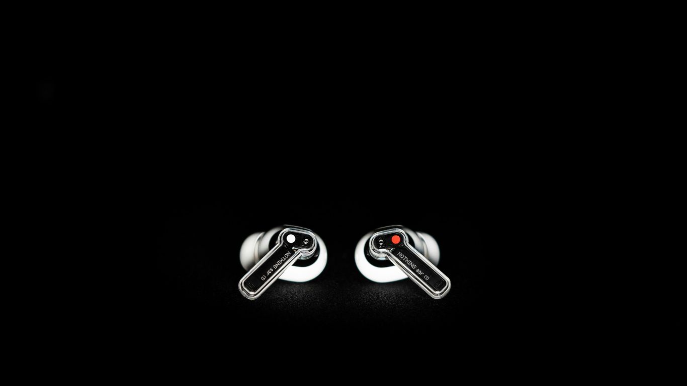 a pair of black and white cufflinks on a black background