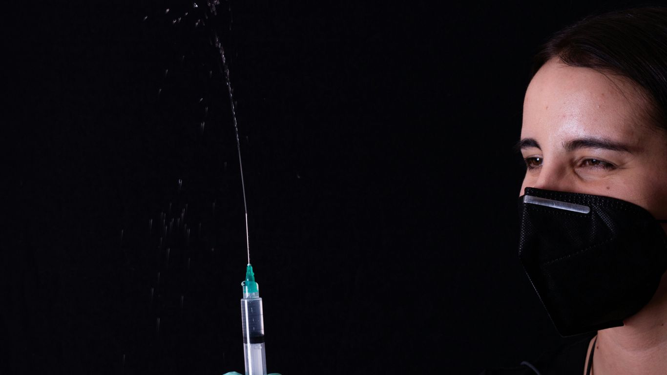 person holding green and black plastic tube