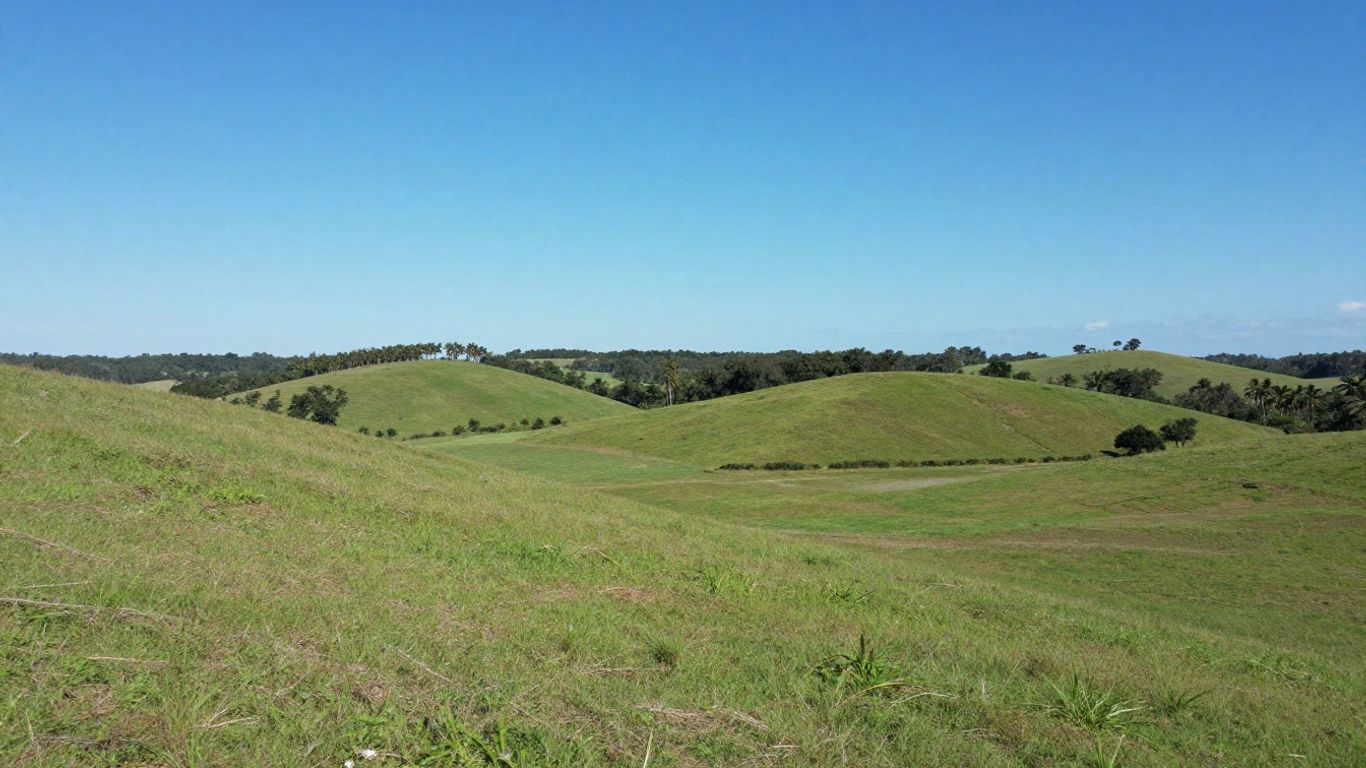 Florida land parcel with green hills and blue sky.