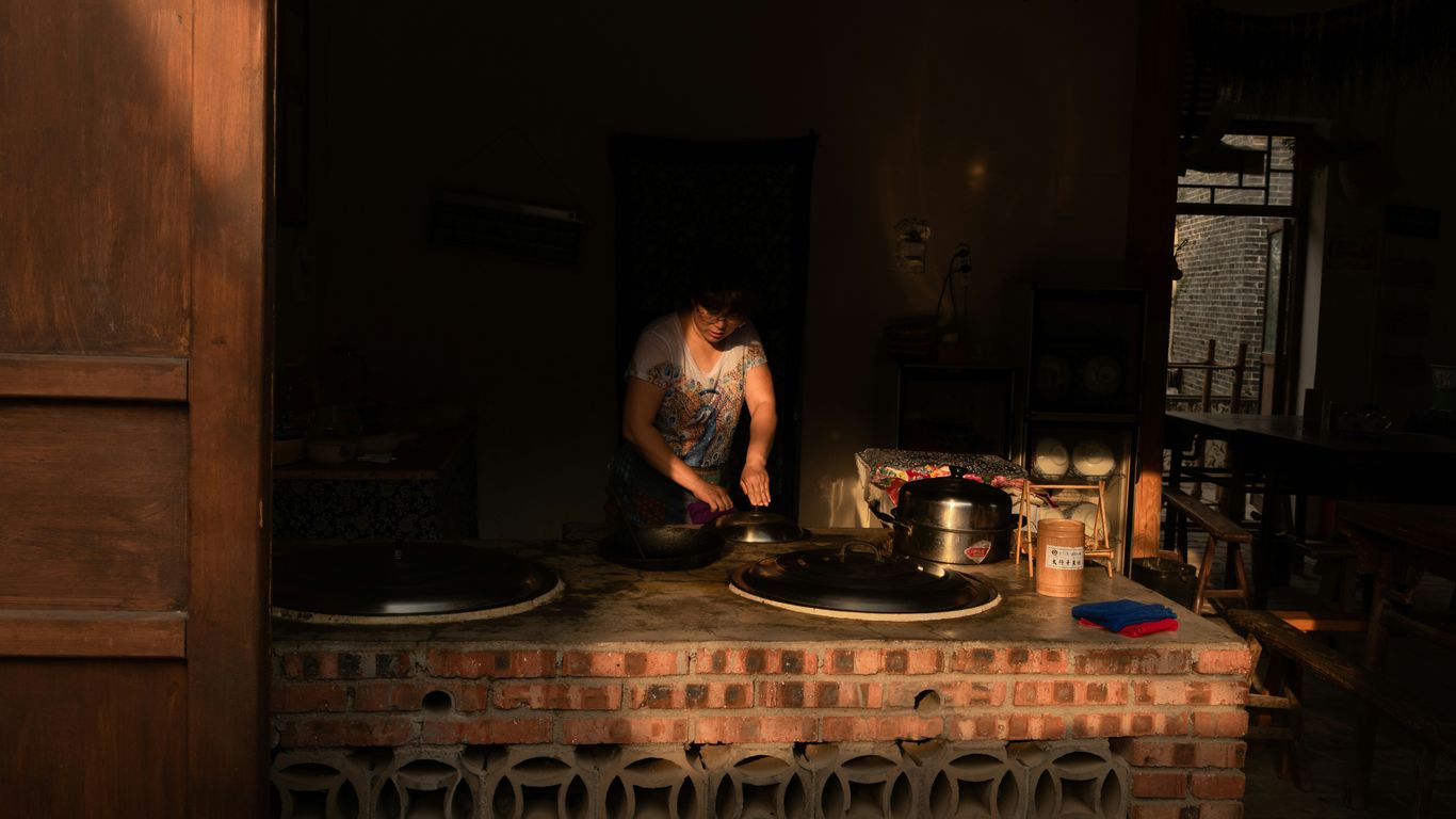 a man is cooking in a brick kitchen