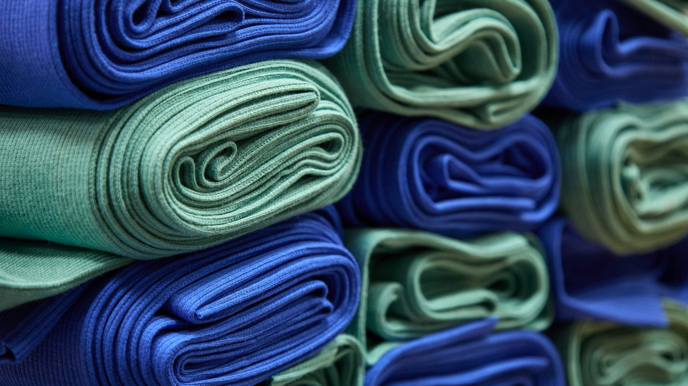 a stack of folded blue and green cloths