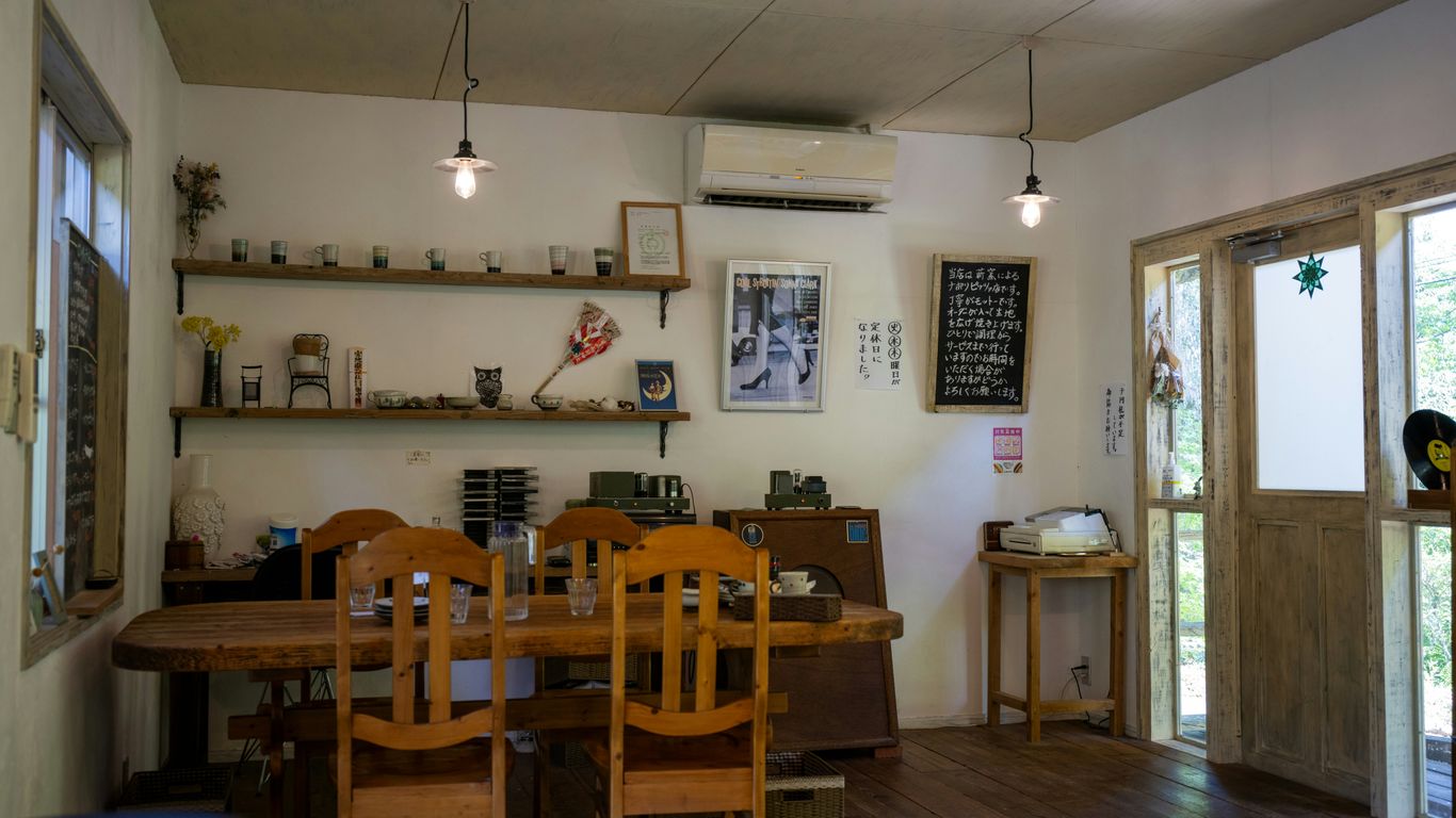 a dining room with a wooden table and chairs