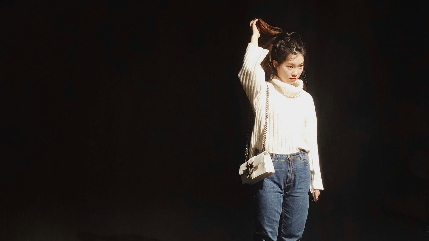 woman standing while holding her hair