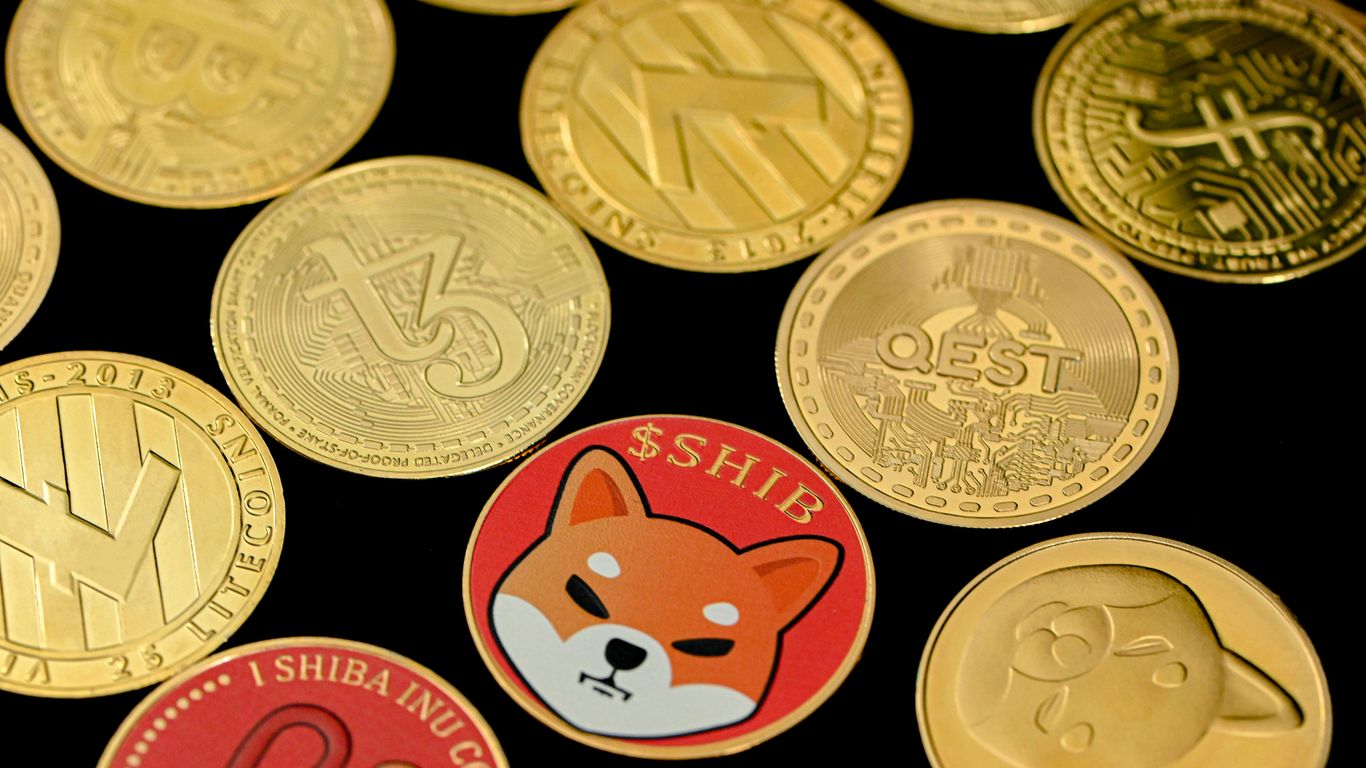 Various cryptocurrency coins and tokens displayed on a surface.