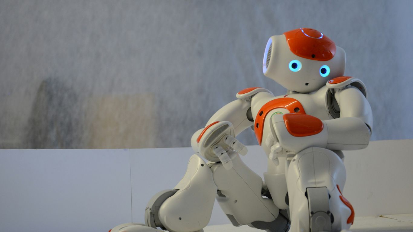 white and orange robot near wall