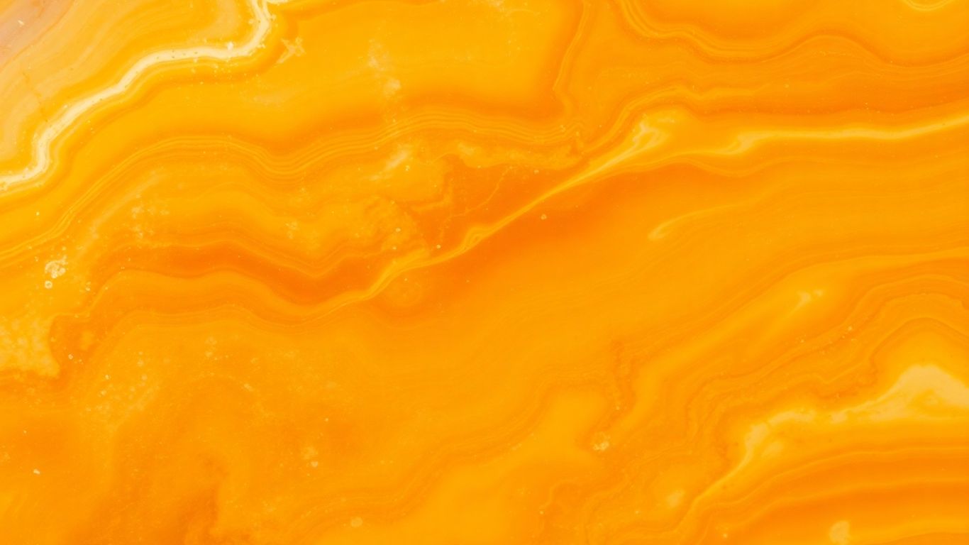 Polished honey onyx gemstone with warm golden-brown swirls.