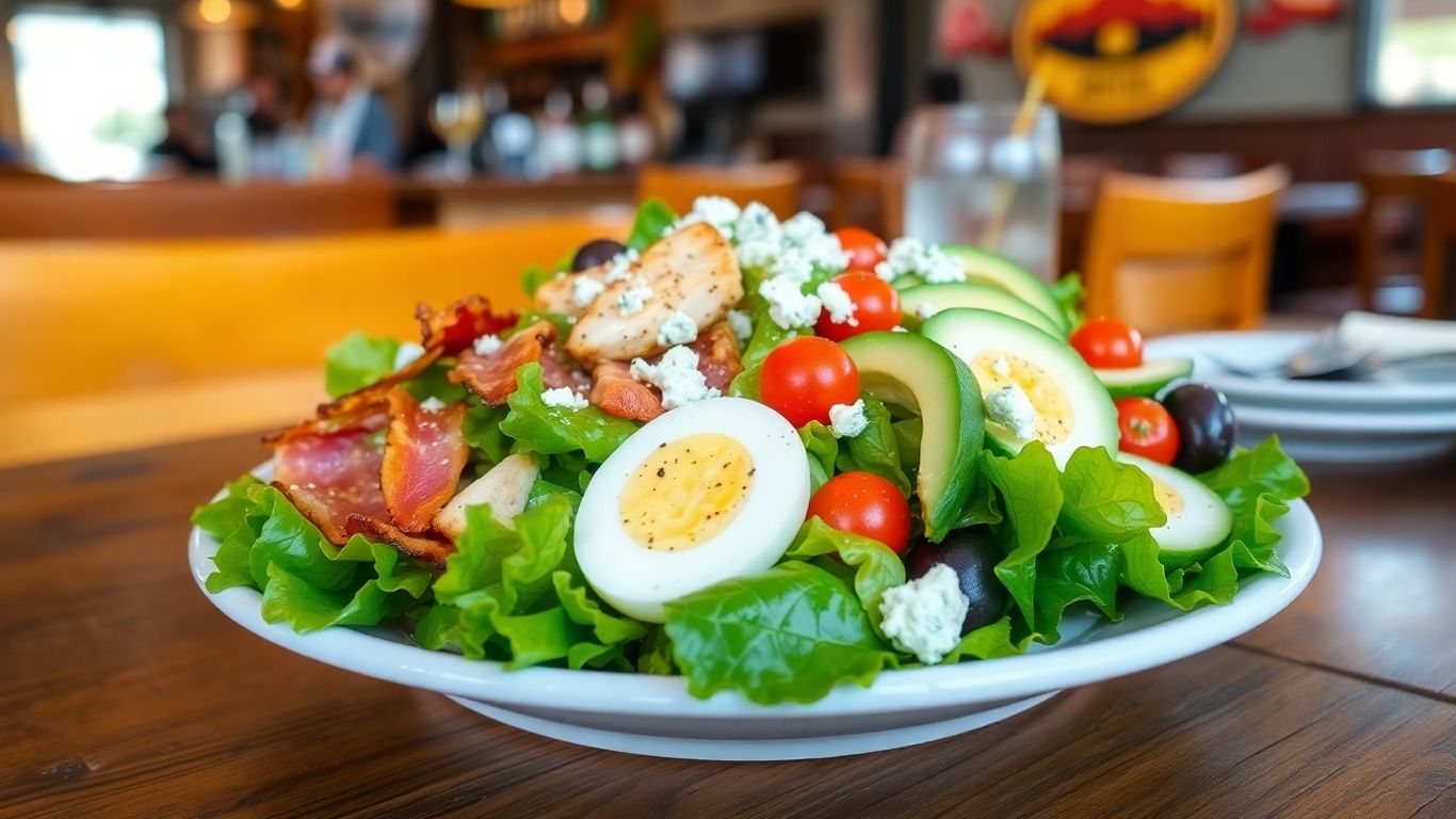Fresh Cobb salad on wooden table in brew pub