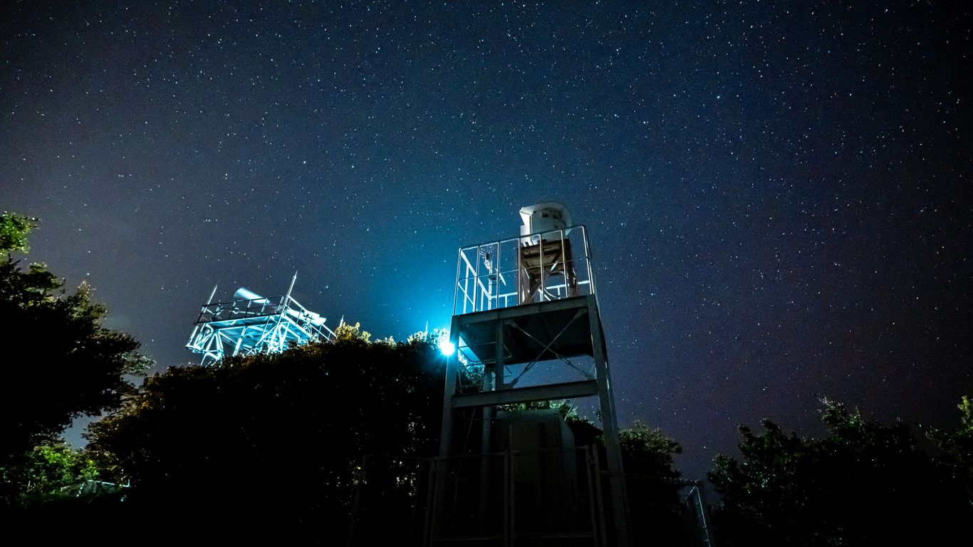 white and black tower under blue sky during night time