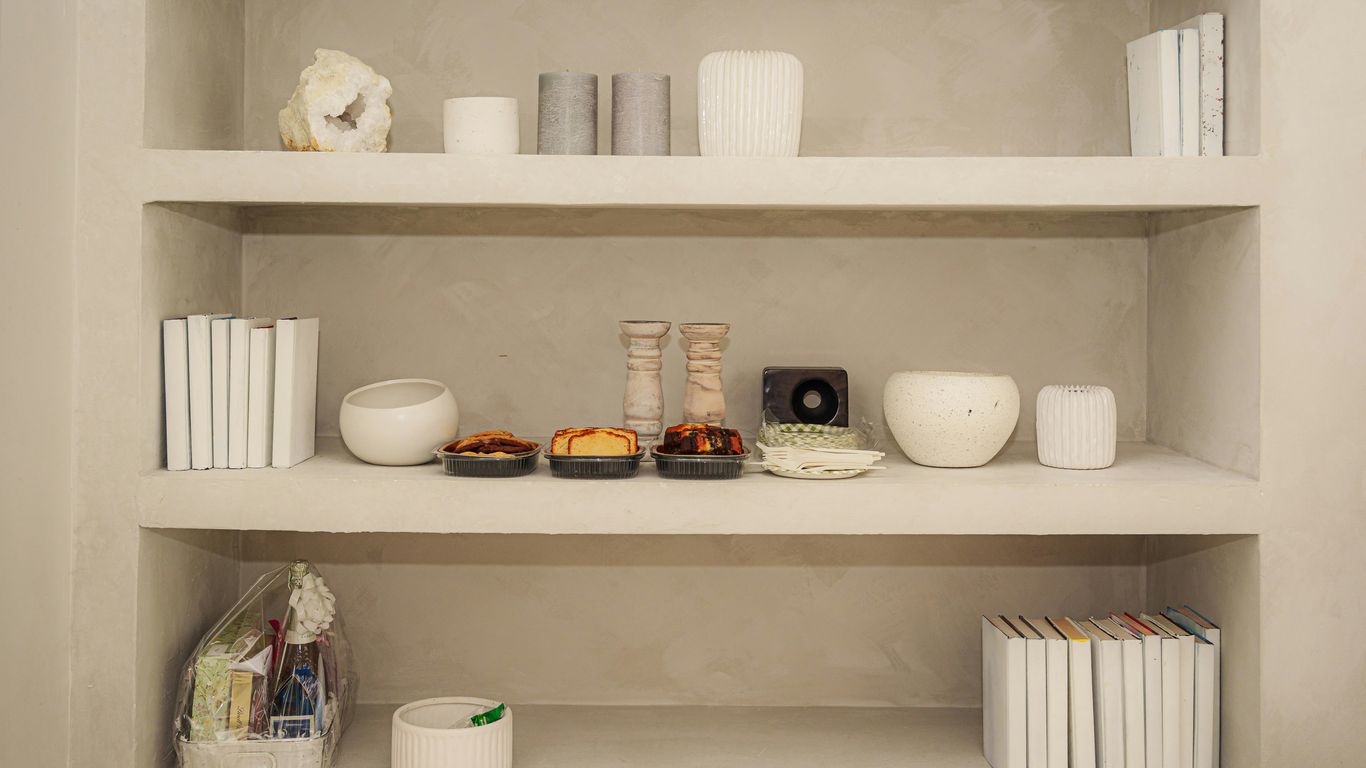 Shelves are filled with decorative objects and books.
