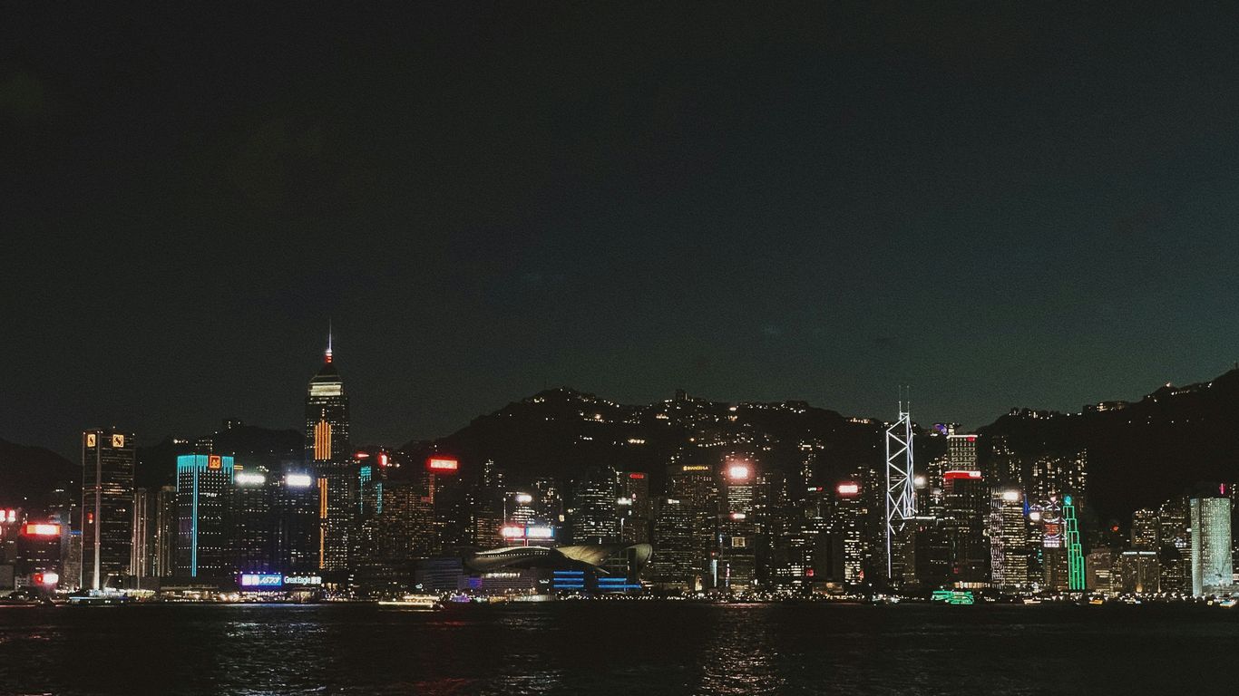 Vibrant cityscape with illuminated skyscrapers at night.