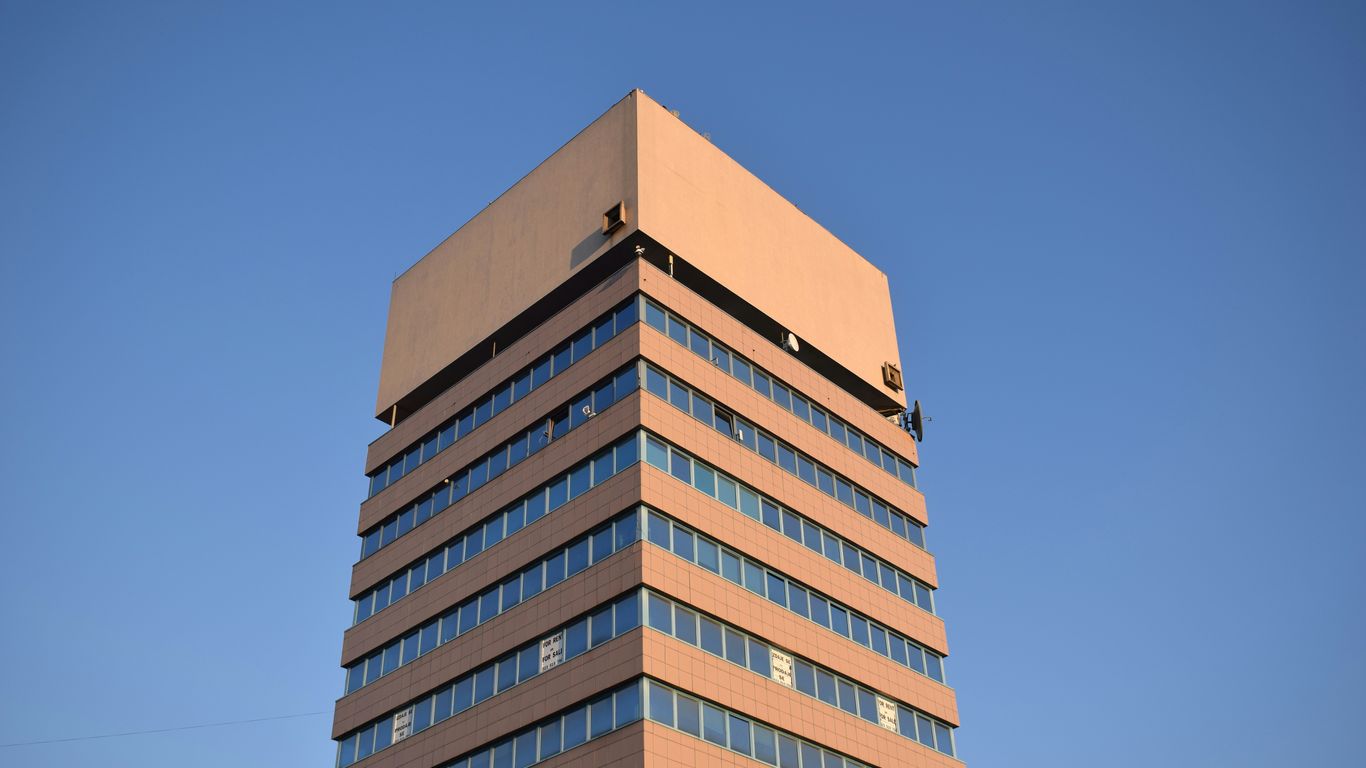 brown and white concrete building under blue sky during daytime