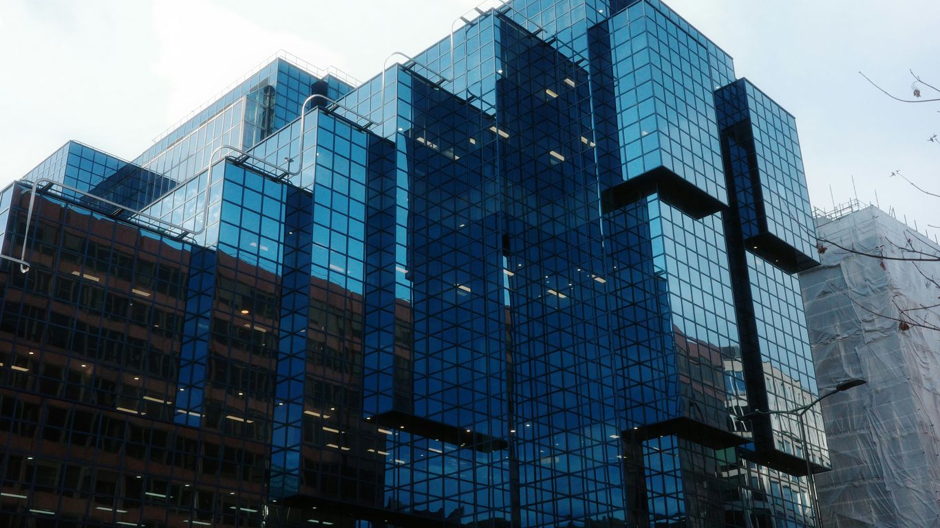 Modern glass skyscraper with geometric facade design