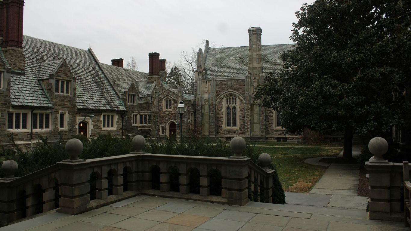 a stone walkway leading to a large building