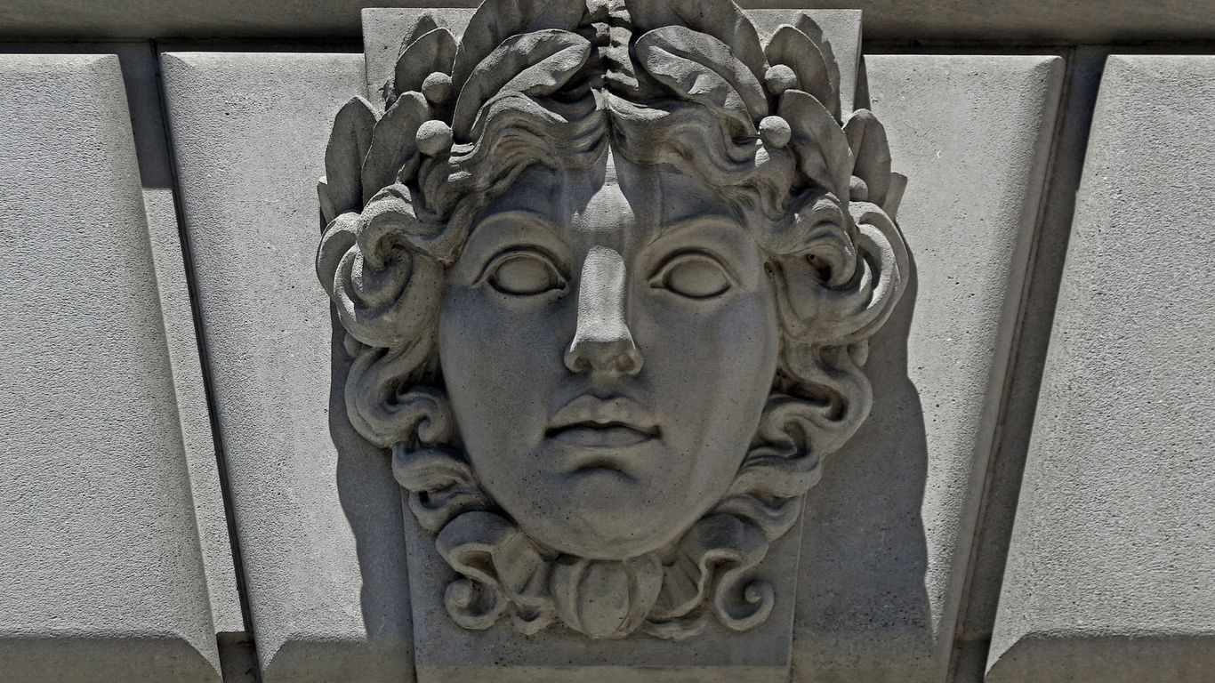 A sculpture of a woman's face on the side of a building