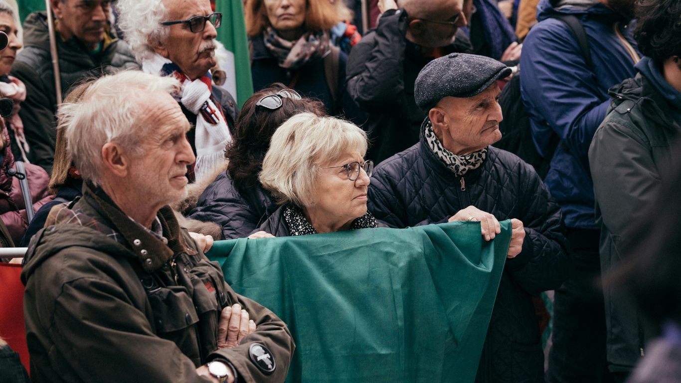 A crowd of people standing around each other