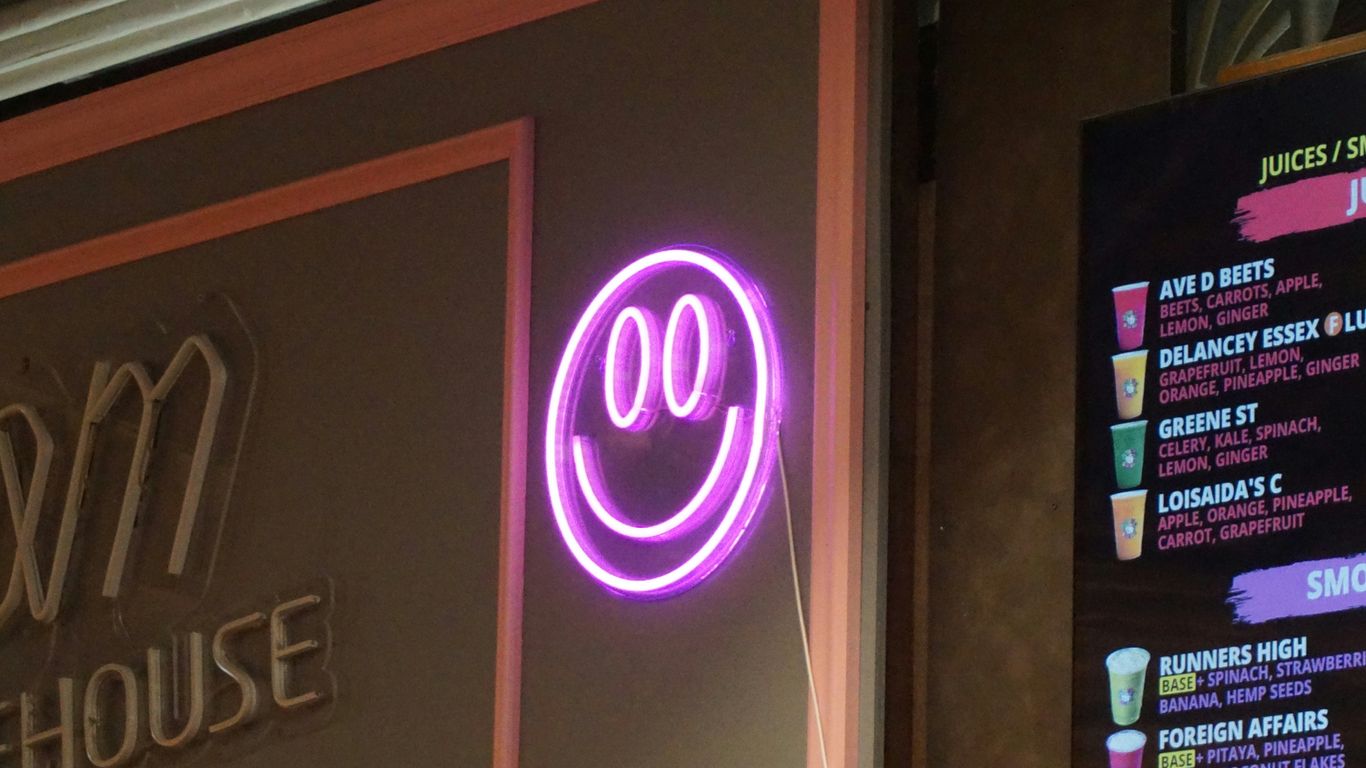 a neon sign that is on the side of a building