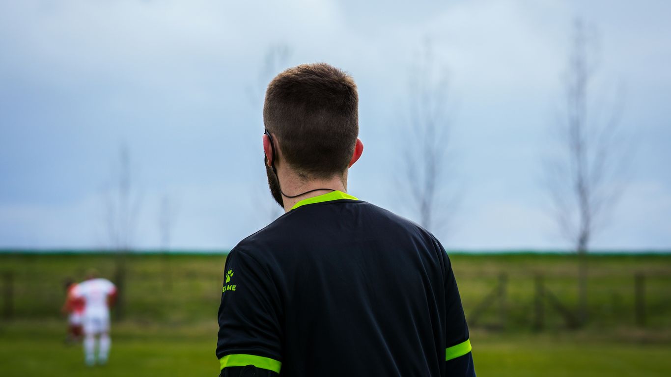 a man standing in a field with a frisbee in his hand