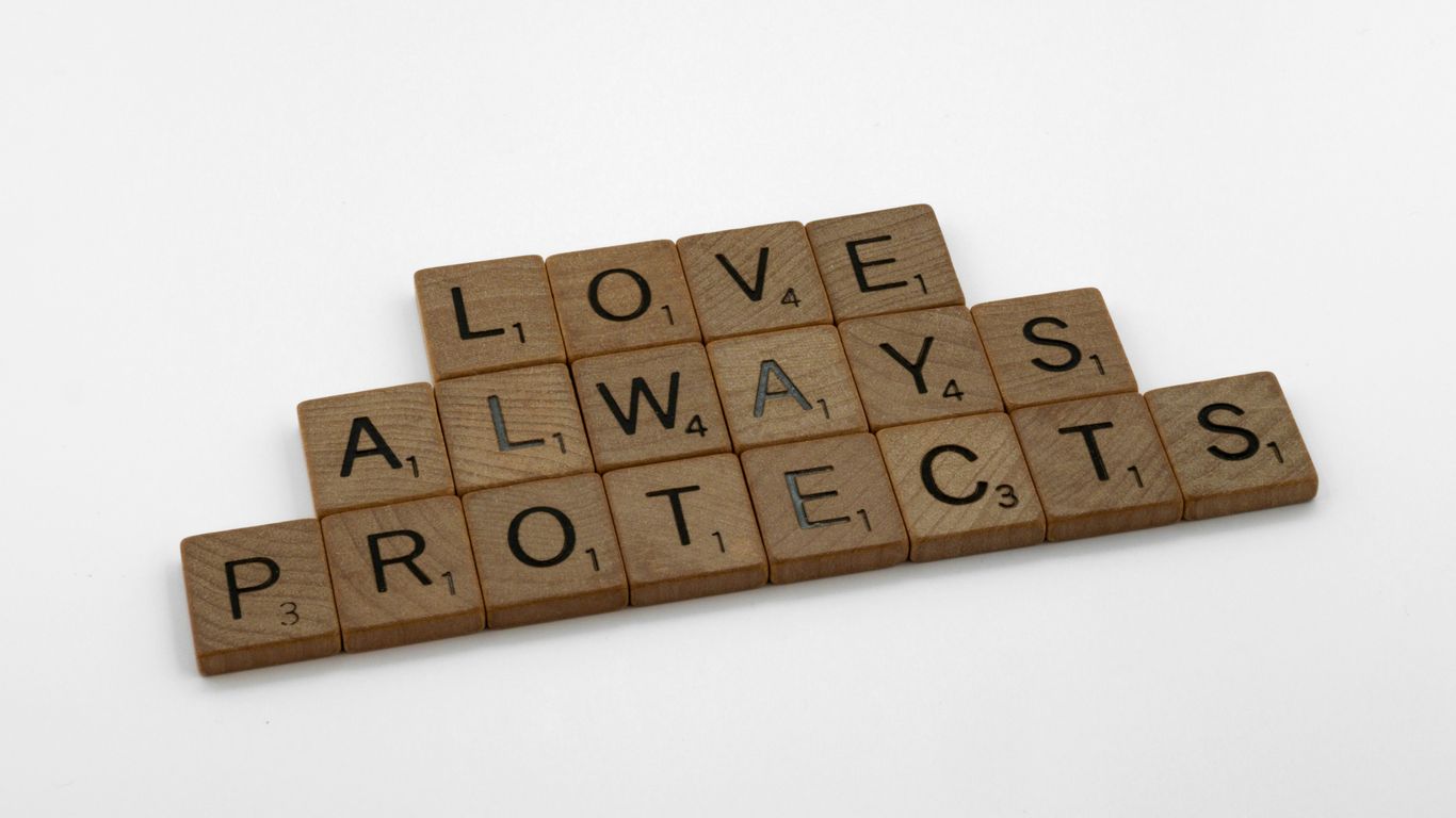 scrabble tiles spelling love, always, protect, and protect
