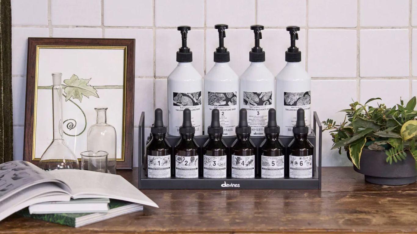 Skincare products displayed neatly on wooden countertop with decorative items.