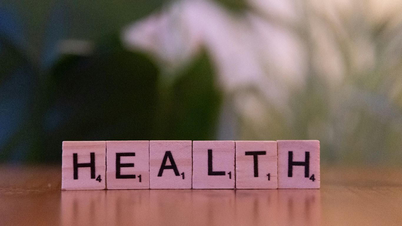 A wooden block spelling the word health on a table