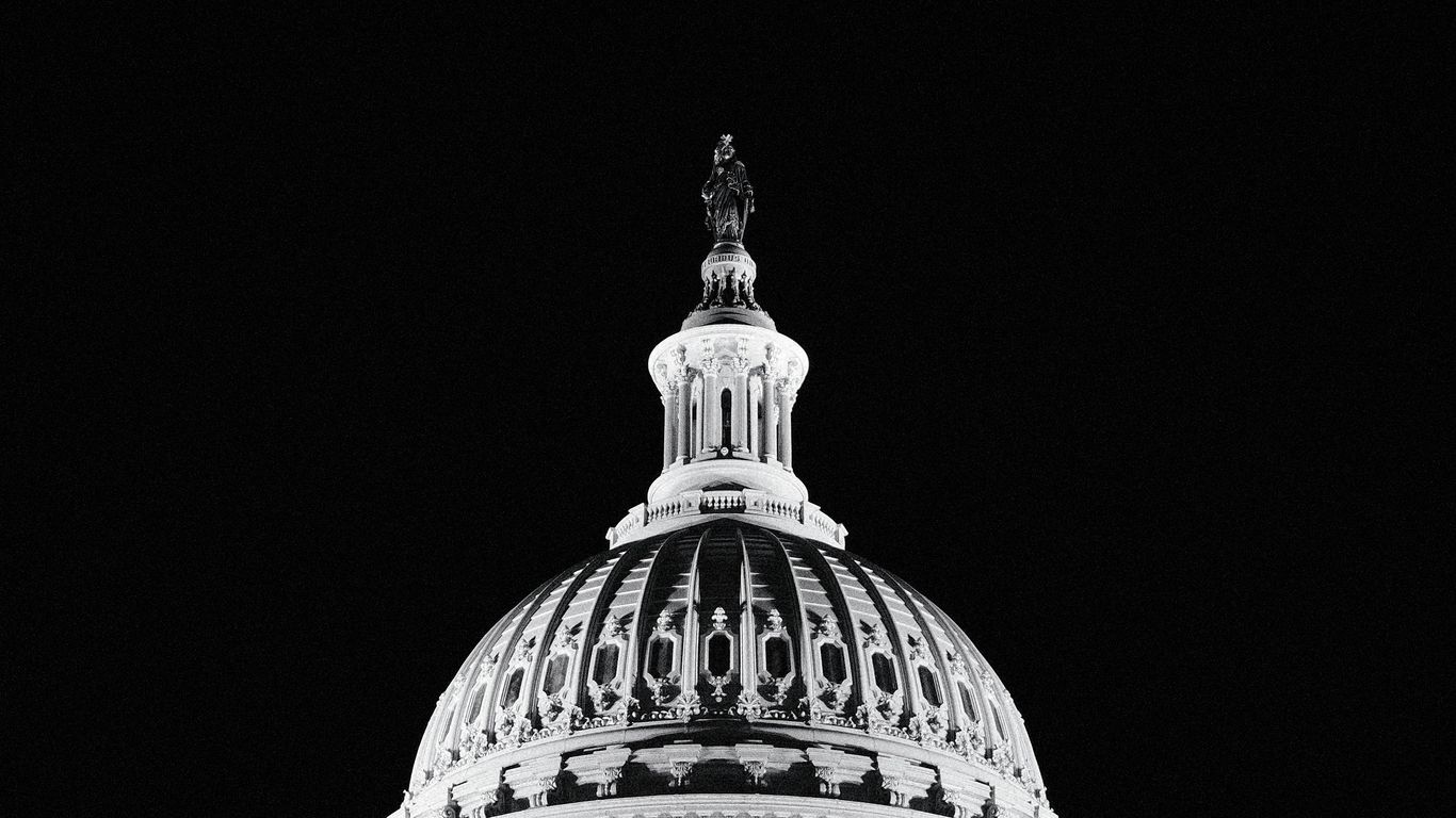 The united states capitol dome against a black sky.