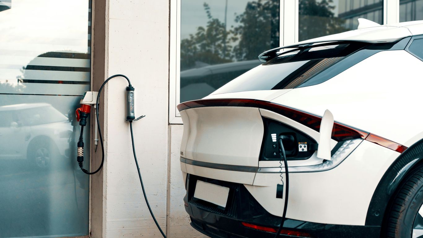 An electric car plugged into a charging station
