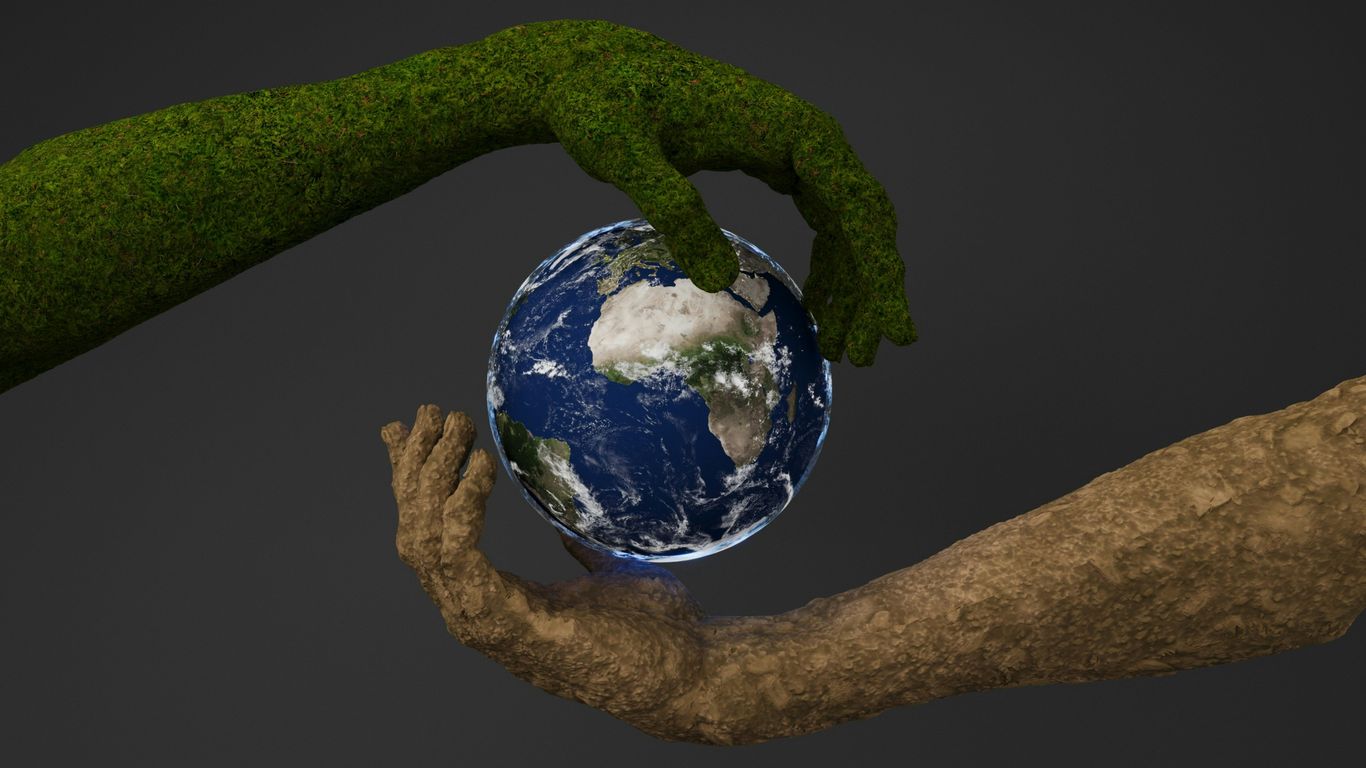 Two hands are holding a small earth globe