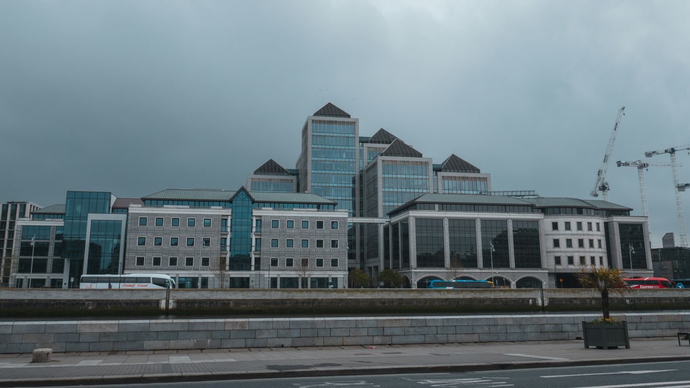 a large building with a lot of windows next to a street