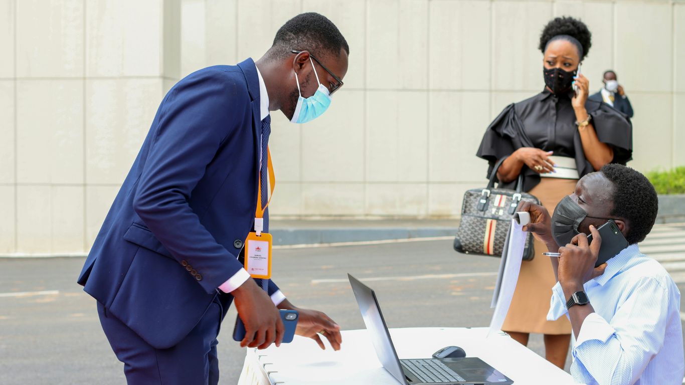 a man wearing a face mask and talking on a cell phone