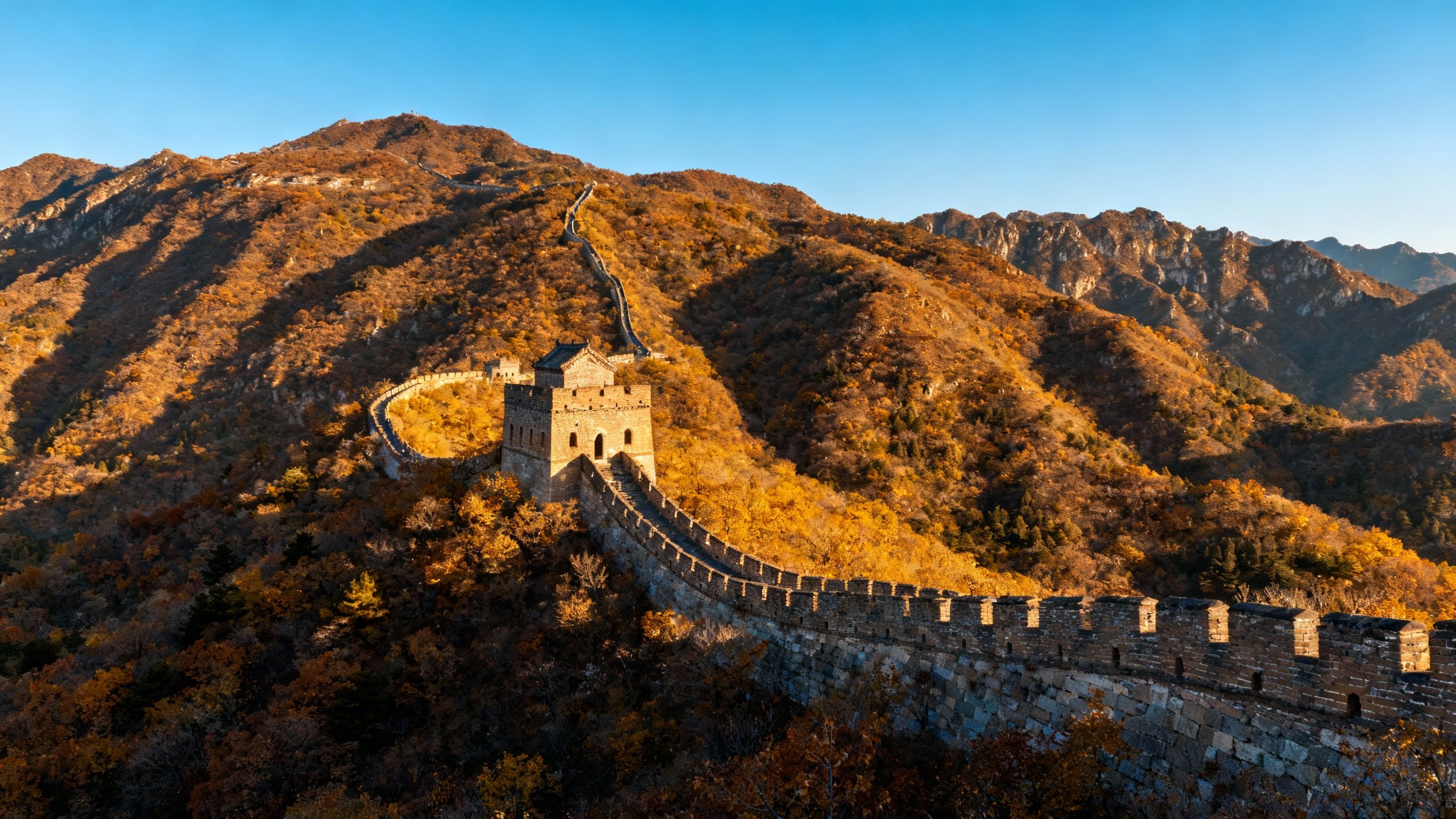 Great Wall of China winding through misty mountains.
