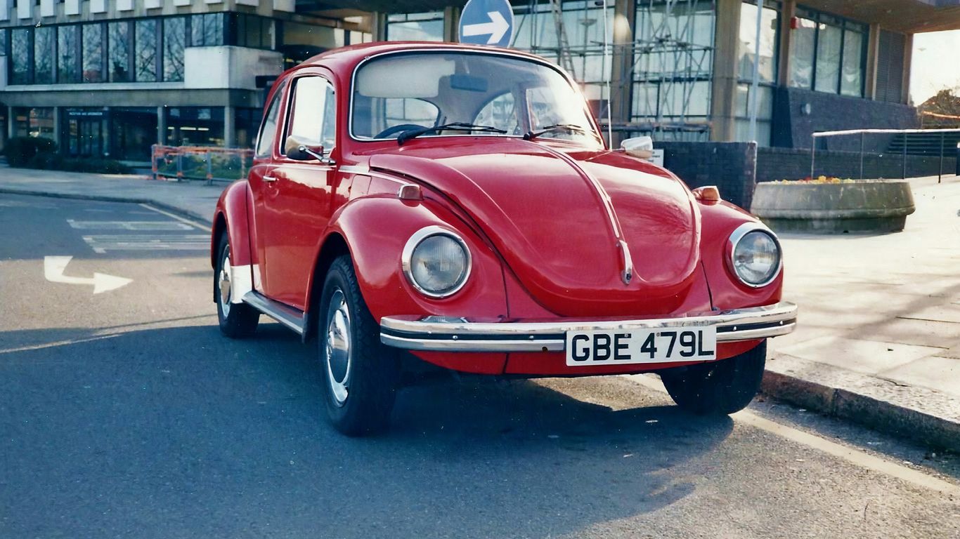 red classic car parked on street during daytime